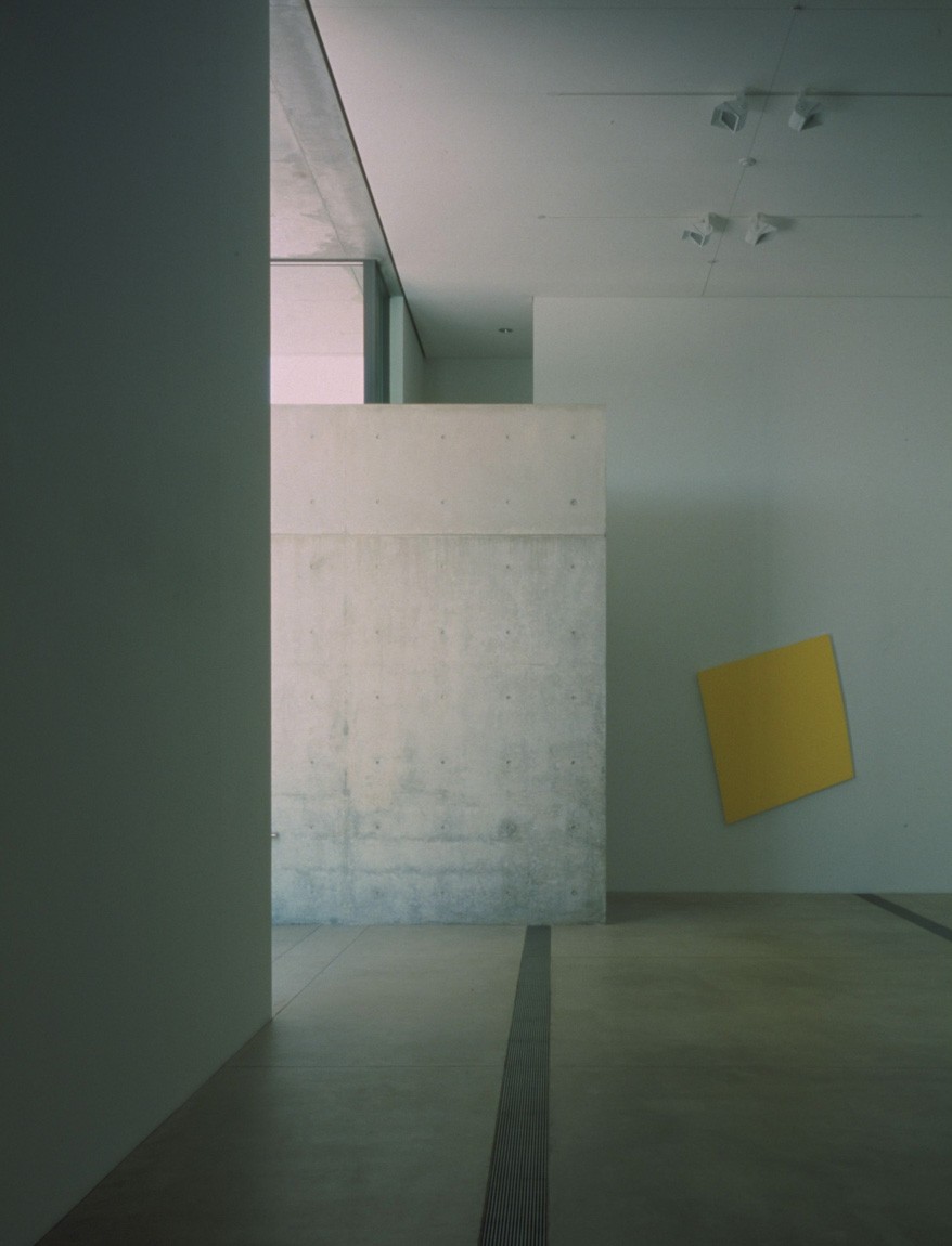 A view of a yellow painting on a distorted square on the north wall of the Main Gallery.
