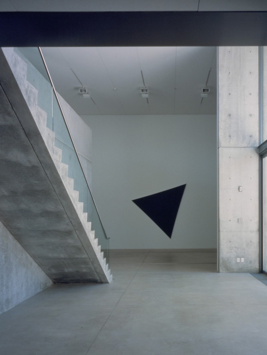 A view of a Kelly black triangular piece in the Main Gallery from the Entrance Gallery.