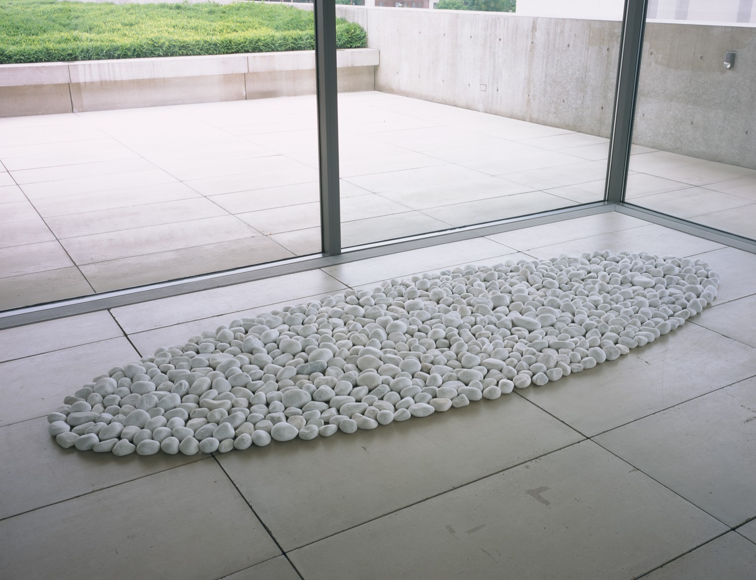 Richard Long's white installation, "Chalk Pebbles Ellipse," on the floor of the Mezzanine.