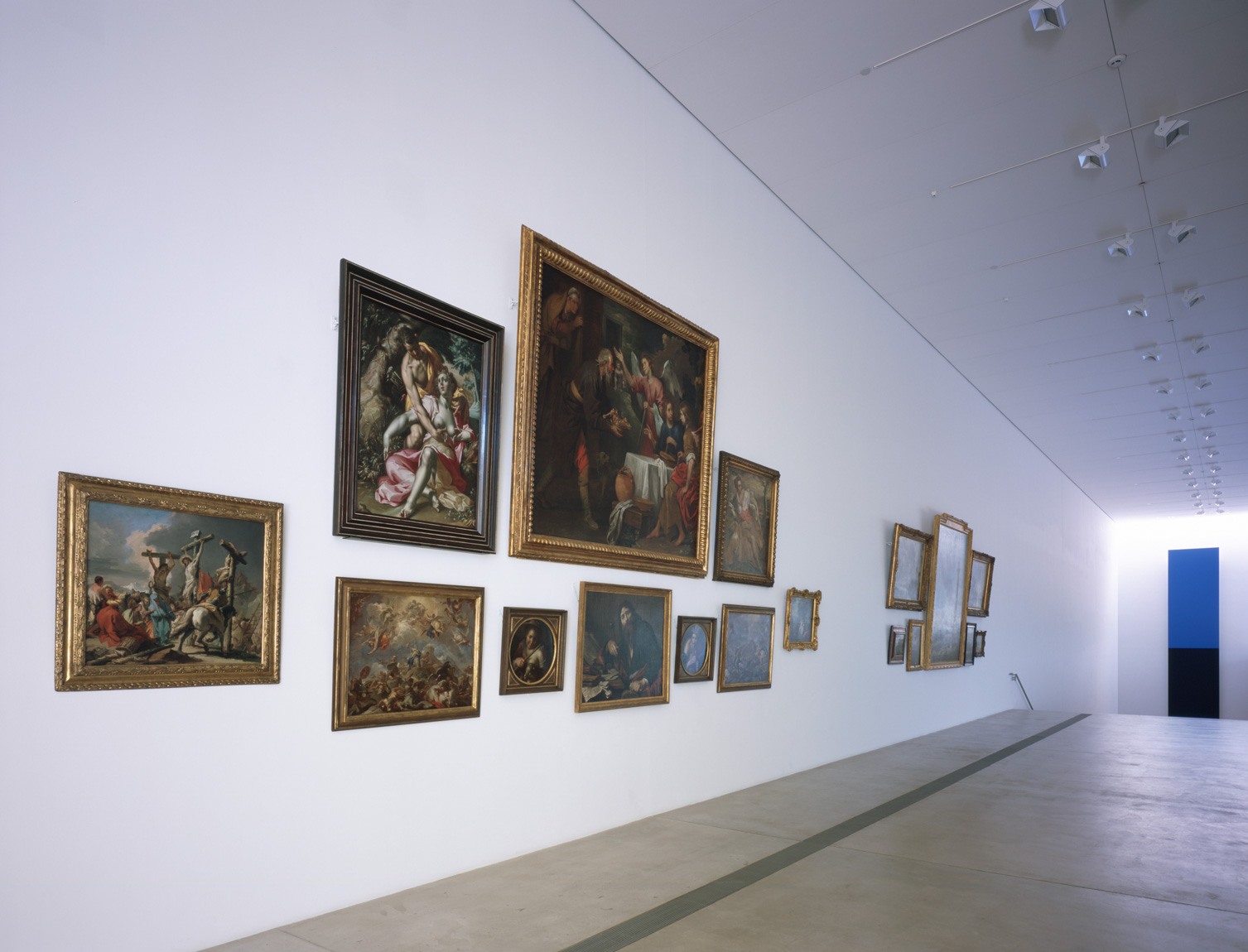 Two groups of paintings hang salon-style in the Main Gallery.