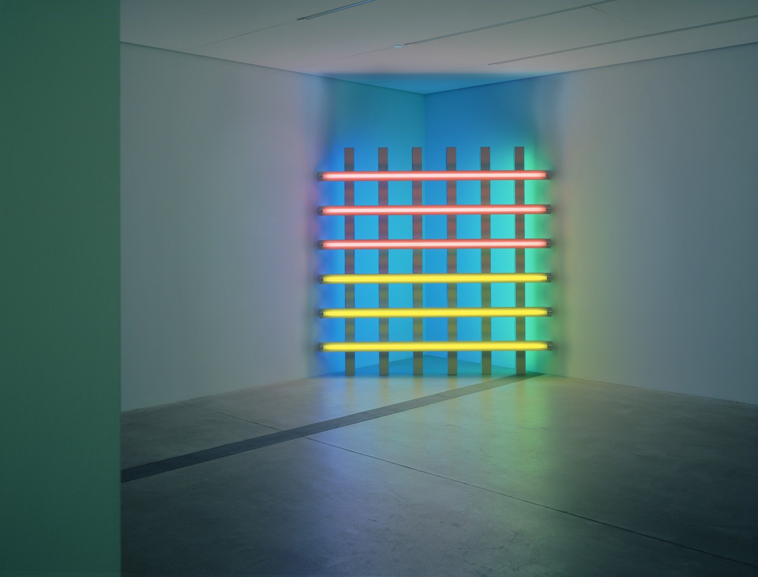 Flavin's "untitled (in honor of Harold Joachim)," a grid of pink, yellow, blue, and green fluorescent lights installed against a corner in the Lower South Gallery.