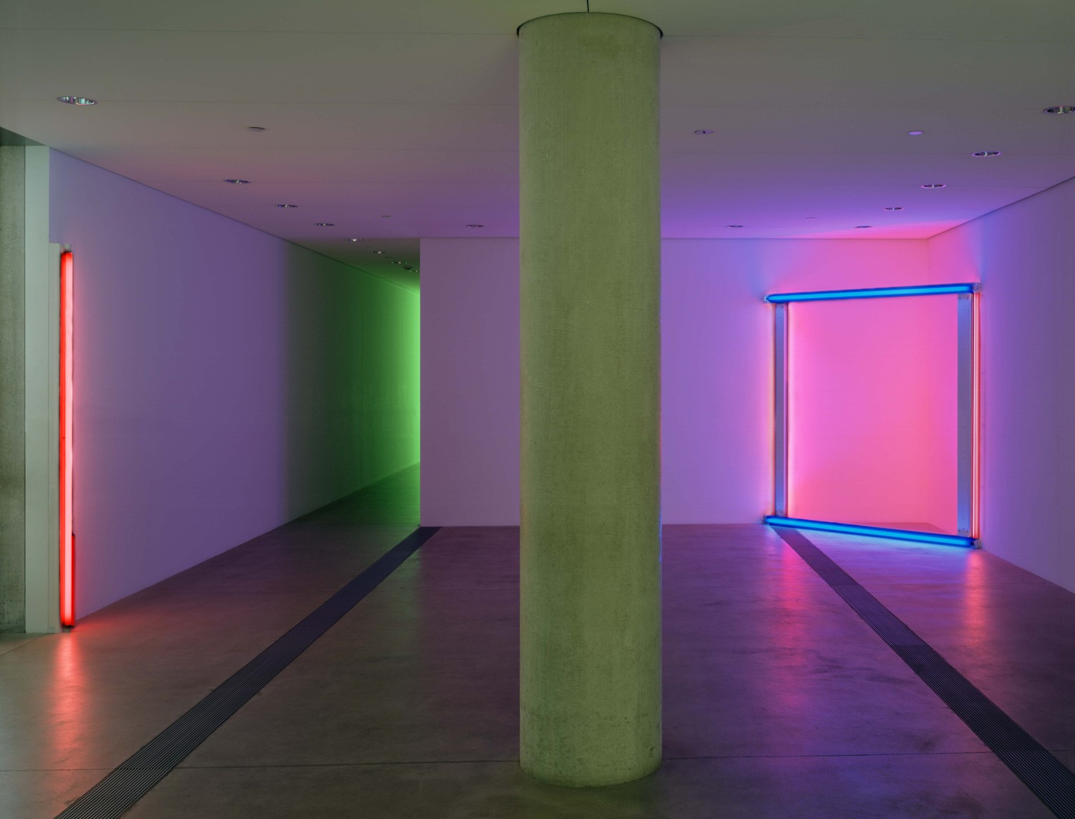 Flavin's bright purple and blue piece "untitled (to the 'innovator' of Wheeling Peachblow)" is installed in the southwest corner of the Entrance Gallery. His piece "untitled," a tall red beam and a shorter pink beam, stands against the eastern wall.