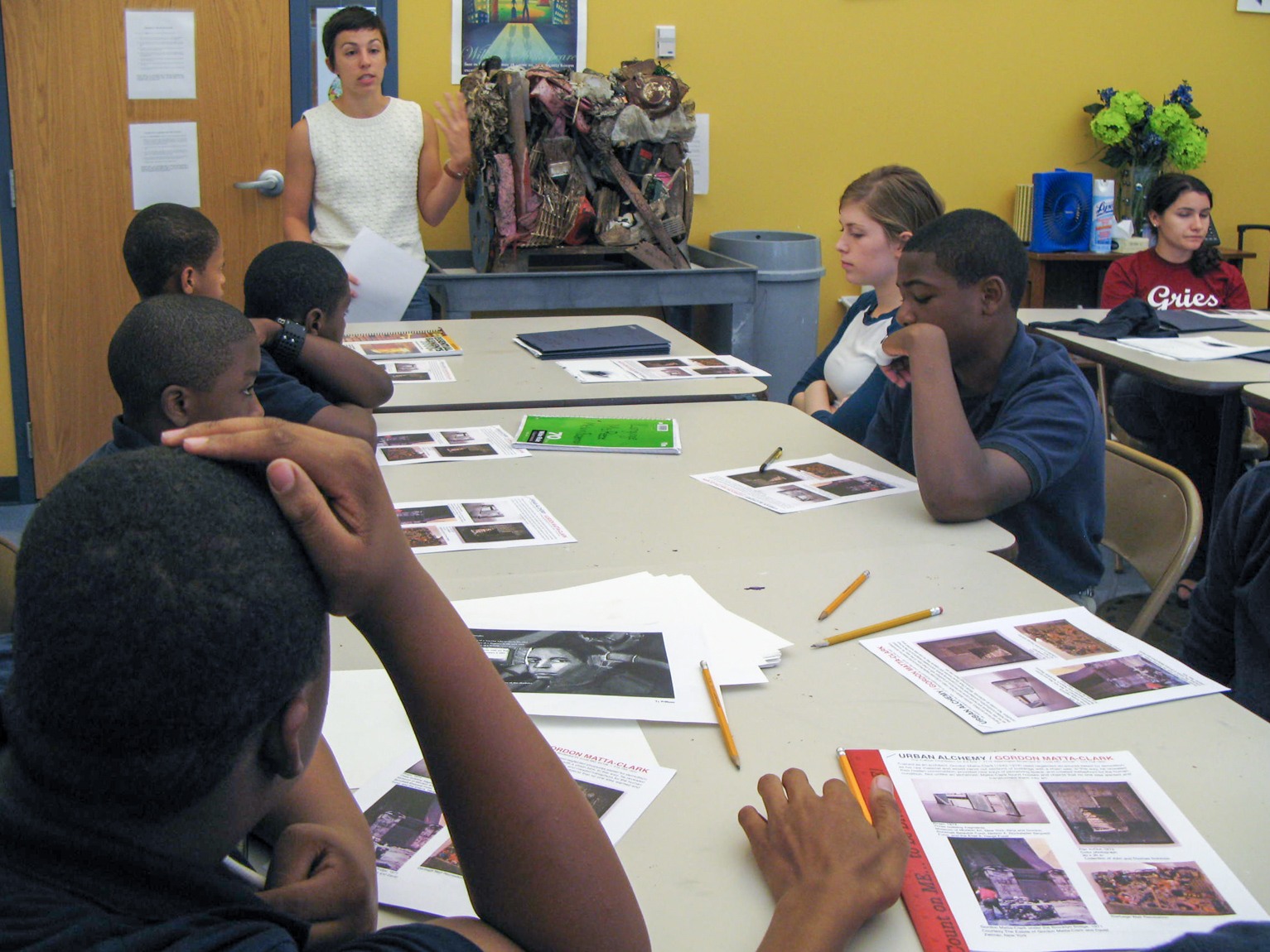 The Assistant Curator of Education discusses with students in a classroom.