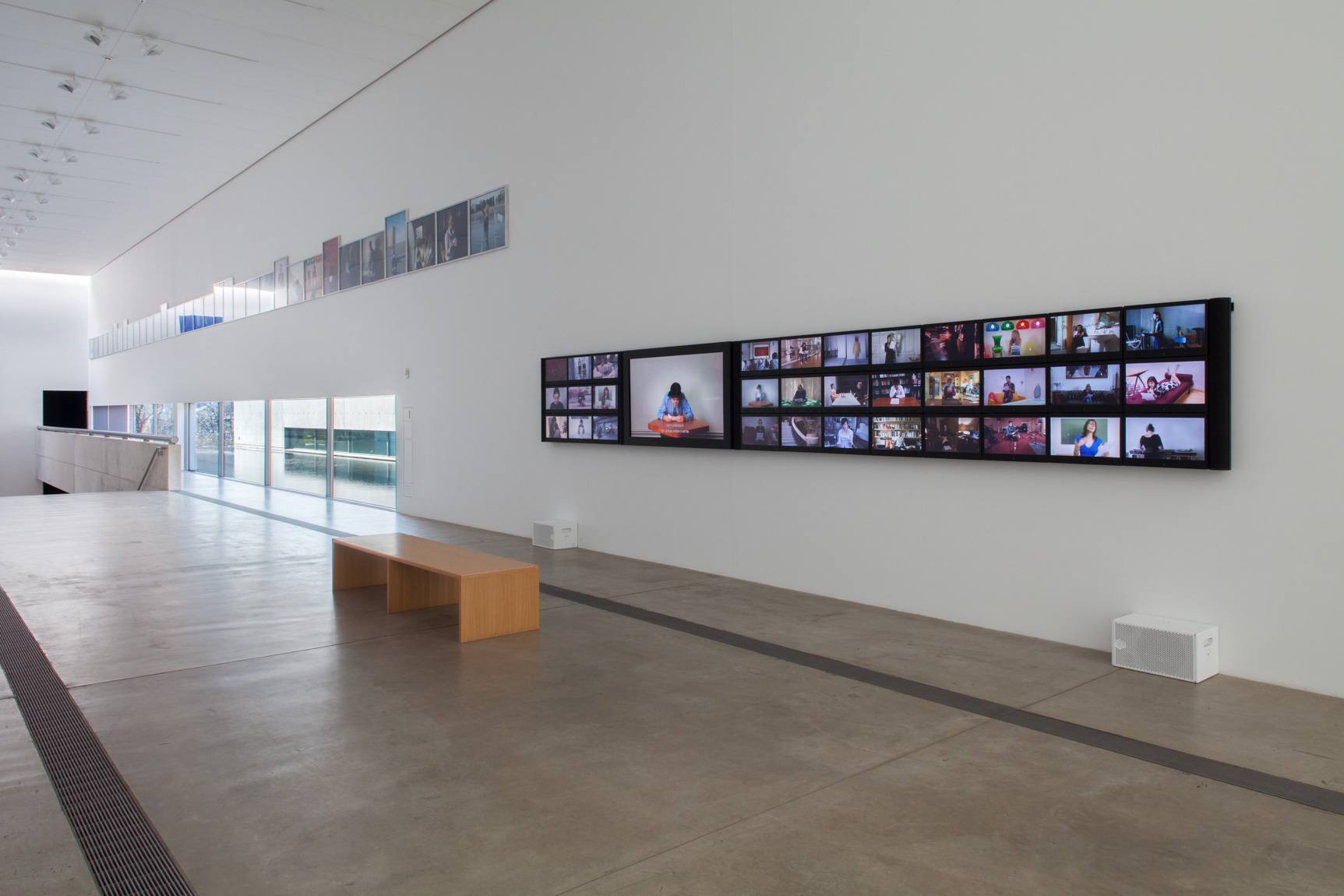 A gallery view of Calle's "Take Care of Yourself" on a large, narrow screen in the Main Gallery.