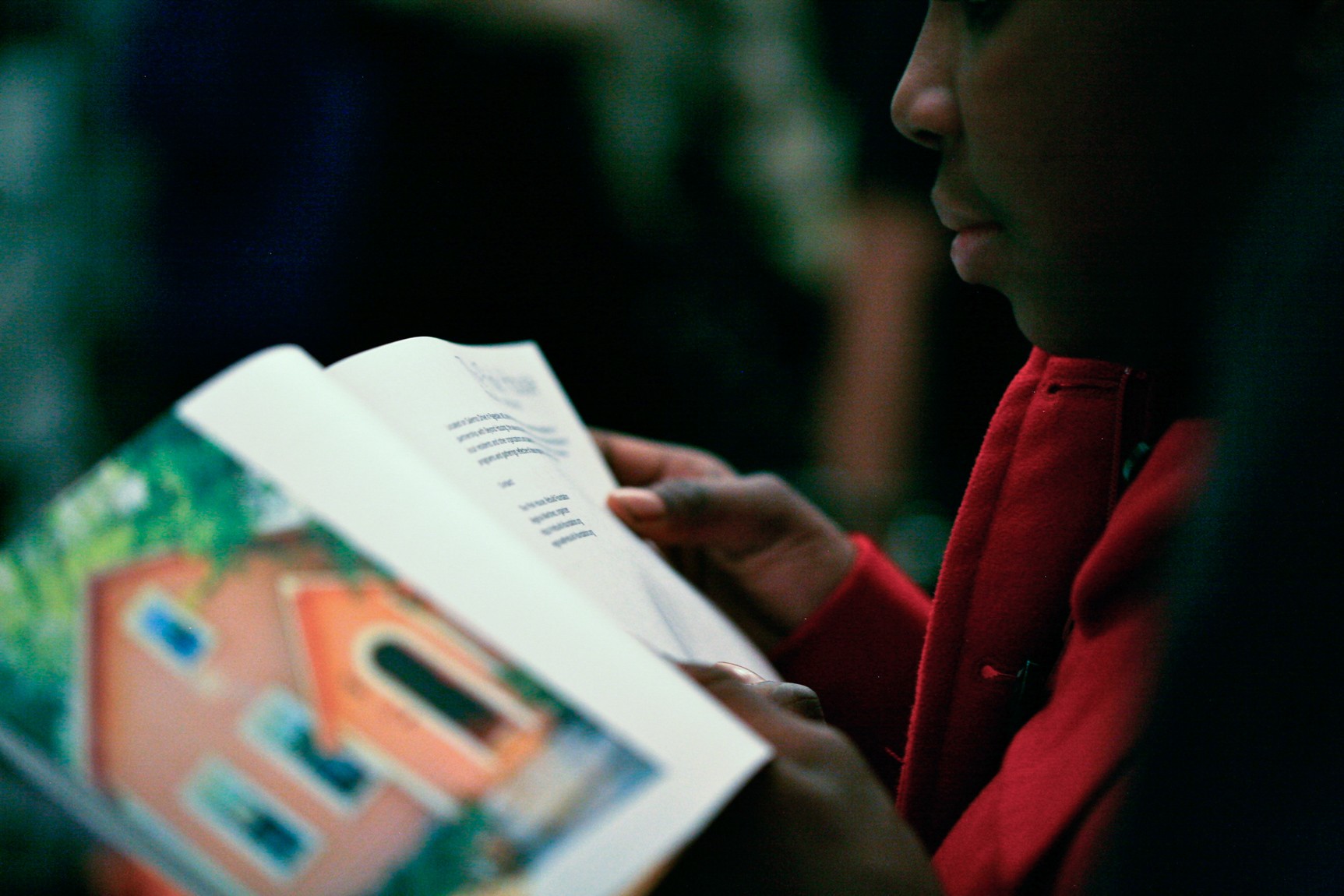 A young visitor reads a page from a guide.