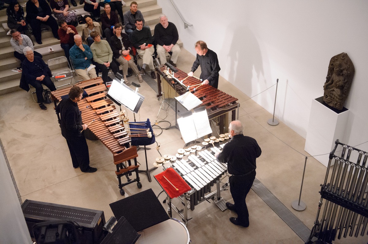 Three glockenspiel players perform in the Lower-Main Gallery for an audience on the Main Staircase.