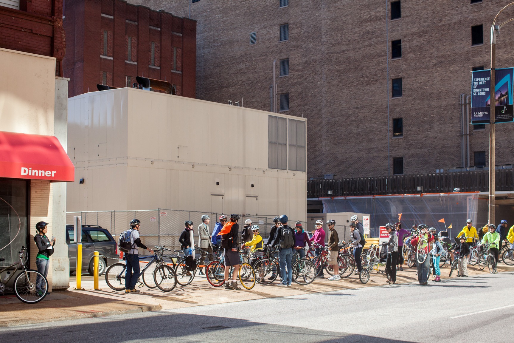 A crowd of cyclists gathered in a parking lot during the bike tour.