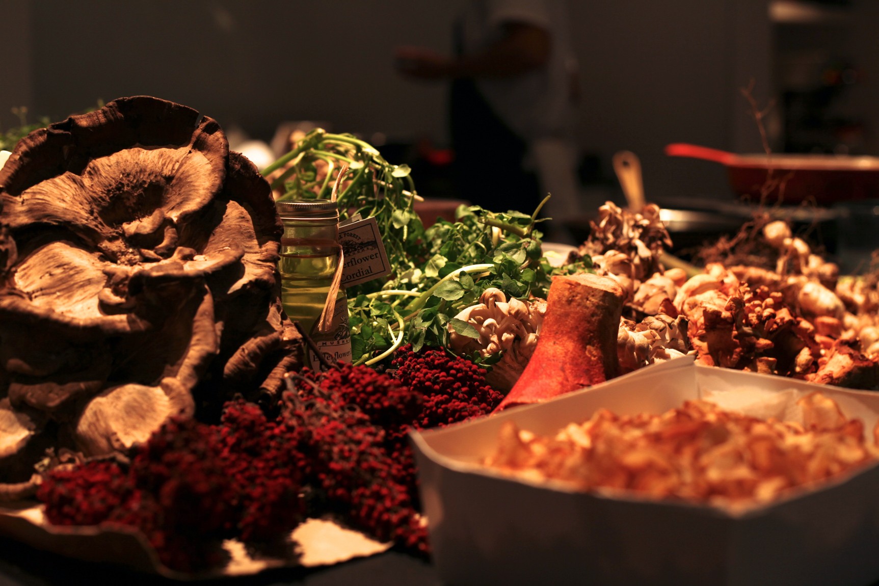 A closeup of the food station with mushrooms and herbs.