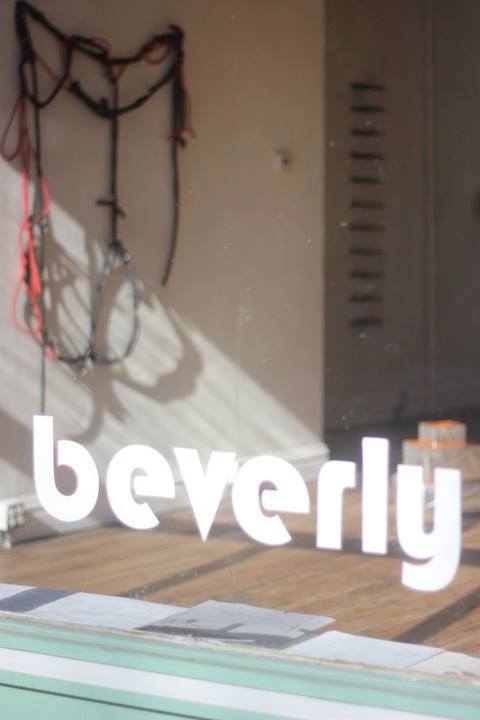 A detail shot of the workshop's name, "beverly," painted on the window.