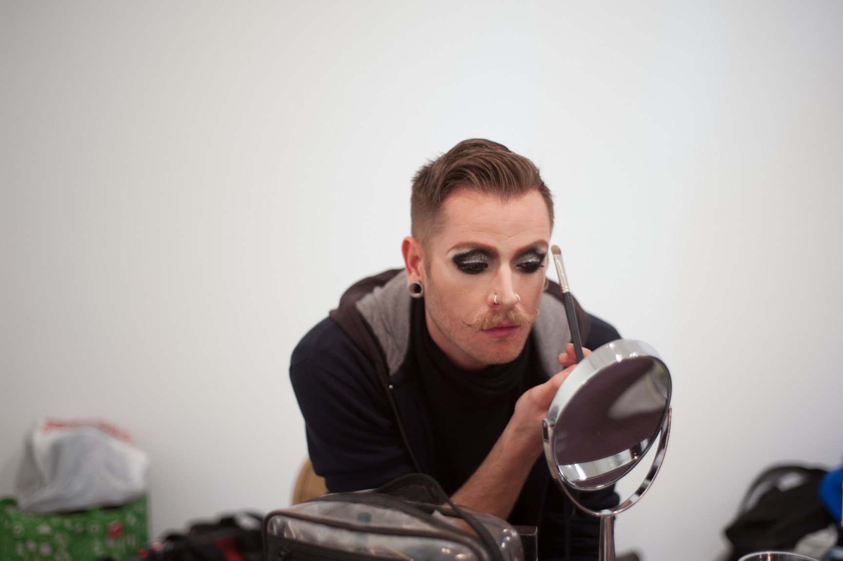 Performer applies their makeup before the drag show.