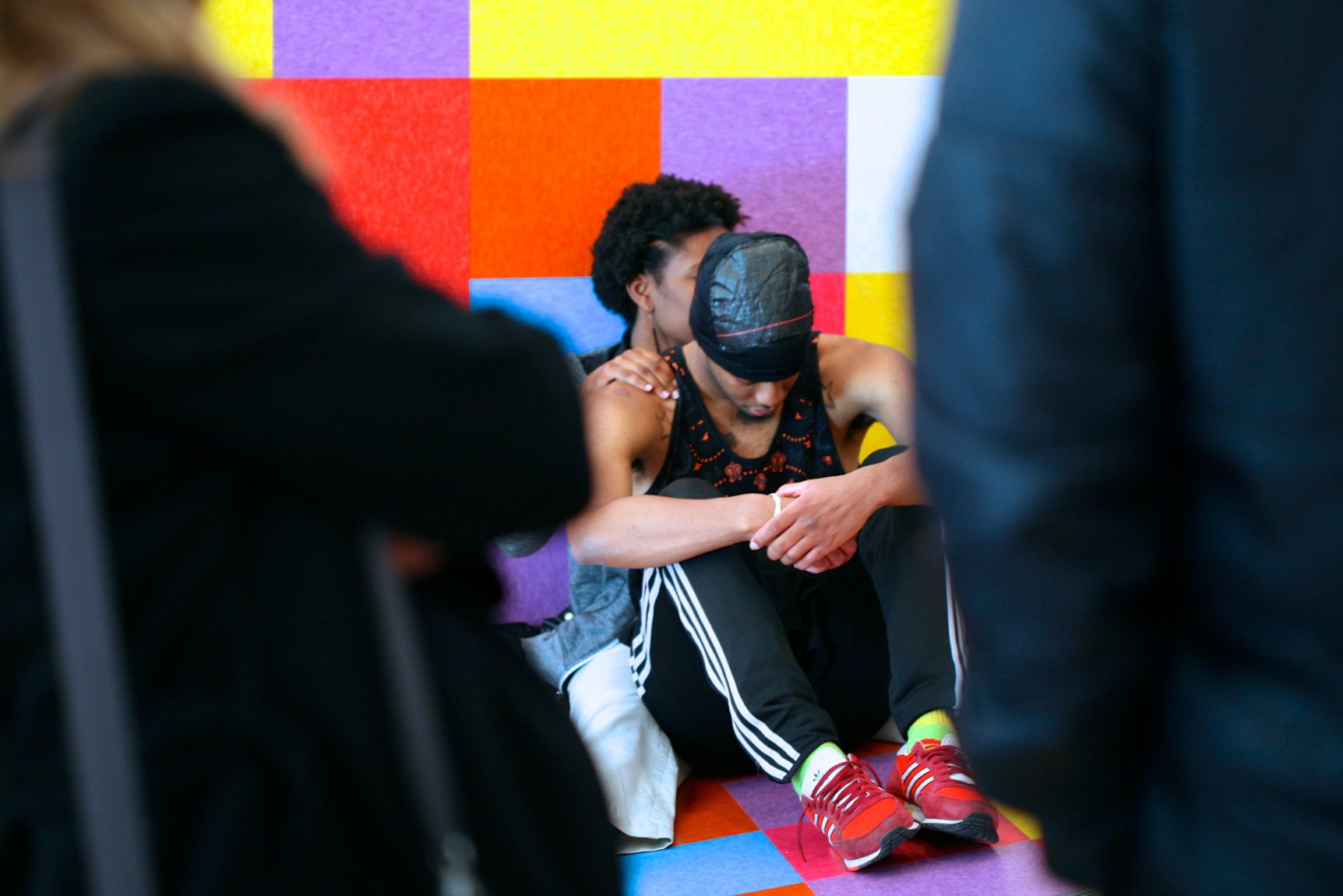 Two dancers take a break and lean against David Scanavino's "Candy Crush."