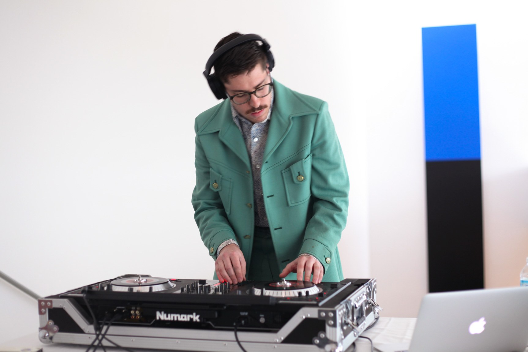A DJ mixing at a turntable in the Main Gallery, with "Blue Black" by Ellsworth Kelly in the background.