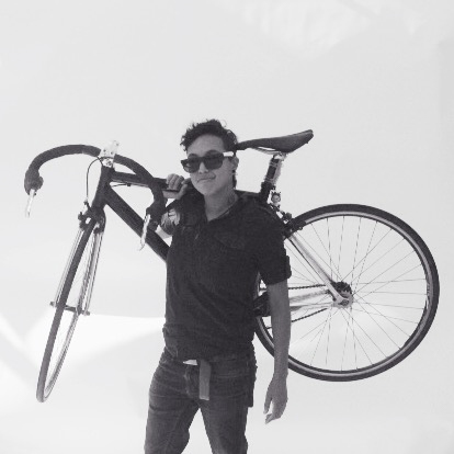 A visitor poses with their favorite object, their bike.