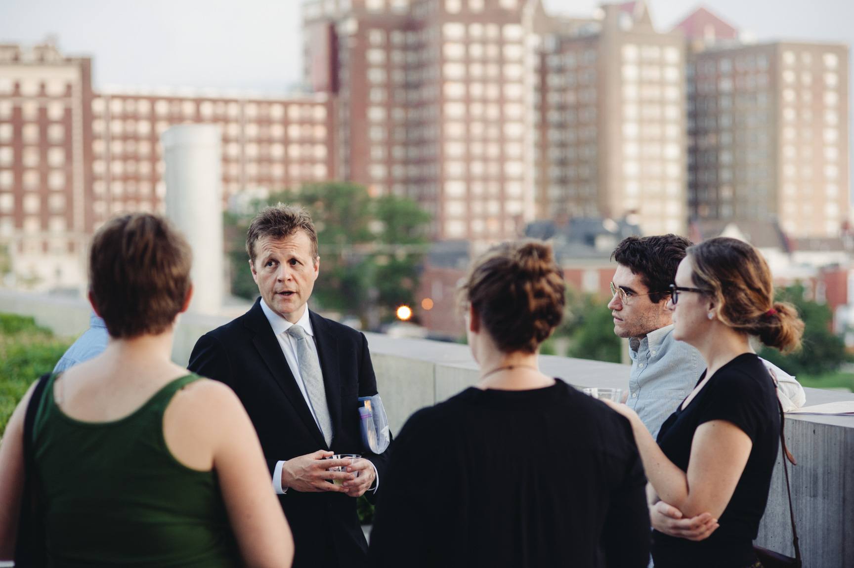 Christian Bök speaks with visitors on the Mezzanine patio.