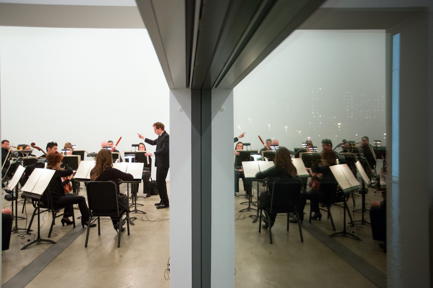 An ensemble of musicians performs in the Cube Gallery.