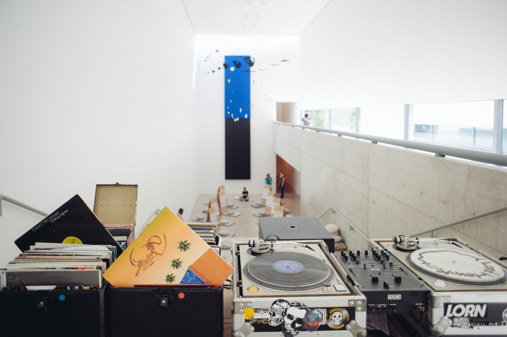 A view of the DJ's record collection and turntables facing Malchionno's meditation session in front of "Blue Black" by Ellsworth Kelly.