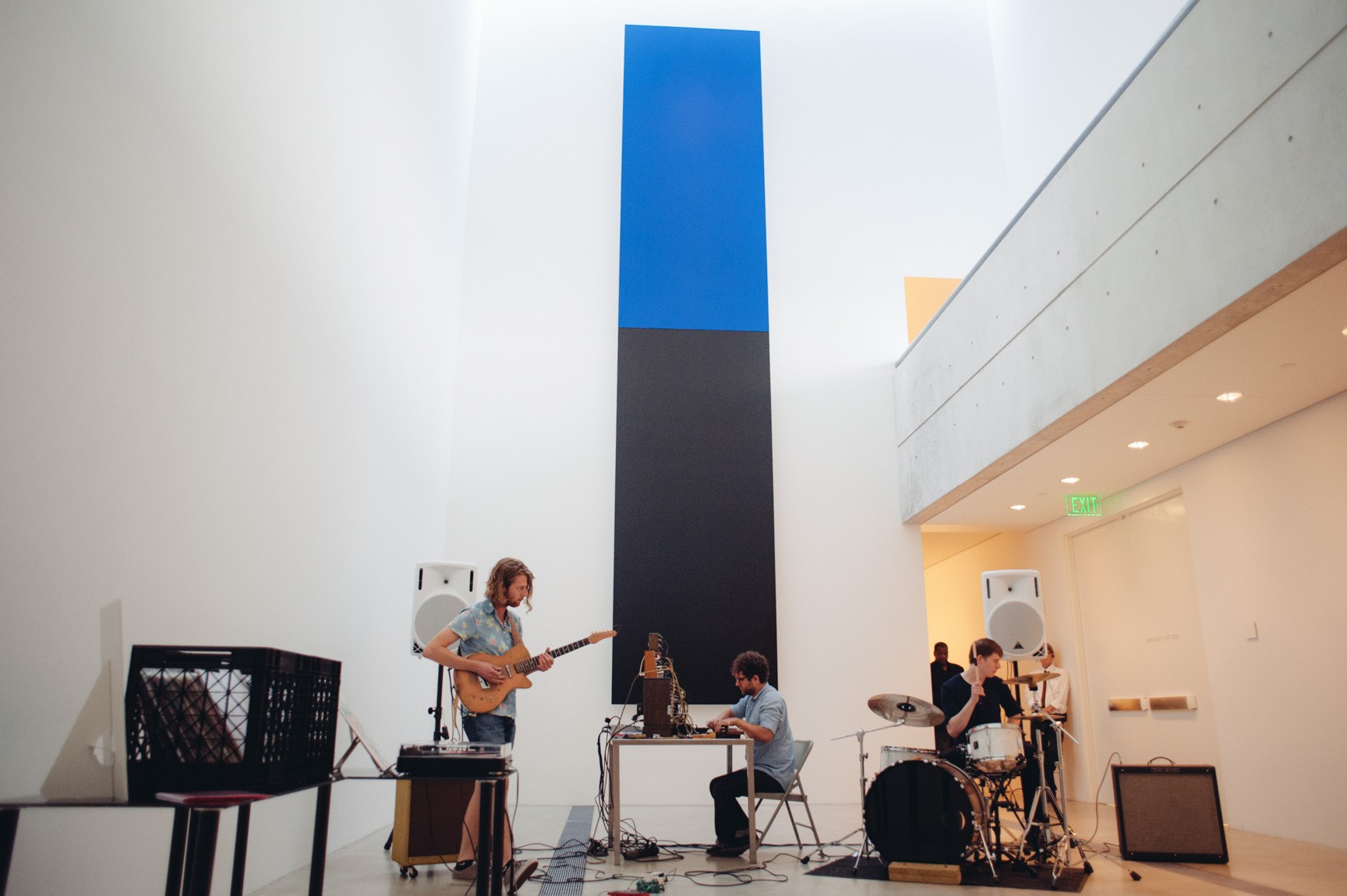 Sun Bros performs in the Lower-Main Gallery in front of Kelly's "Blue Black."