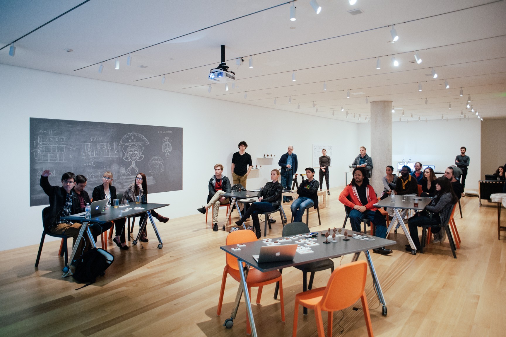 Collaborators attend a presentation in the Lower-West Gallery for a 3-D printing workshop.