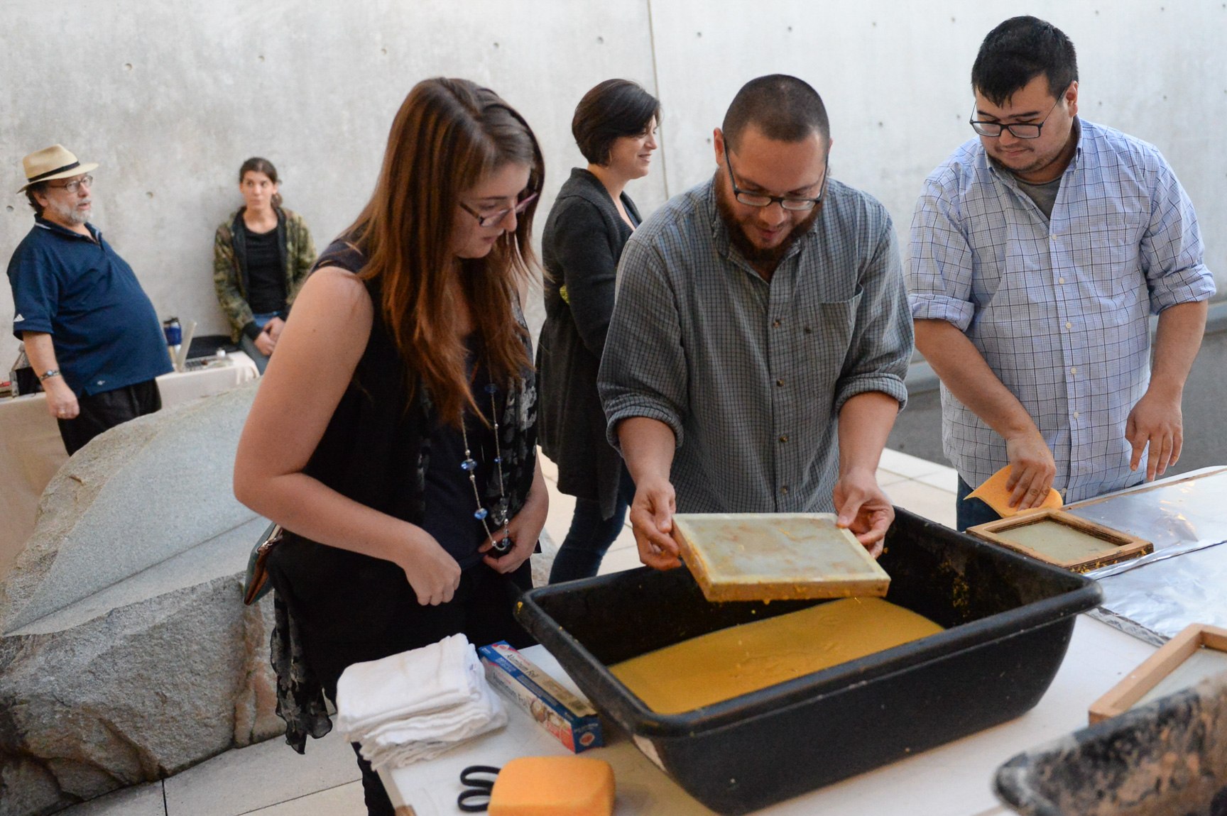 Visitors participate in making by hand paper in the Water Court.