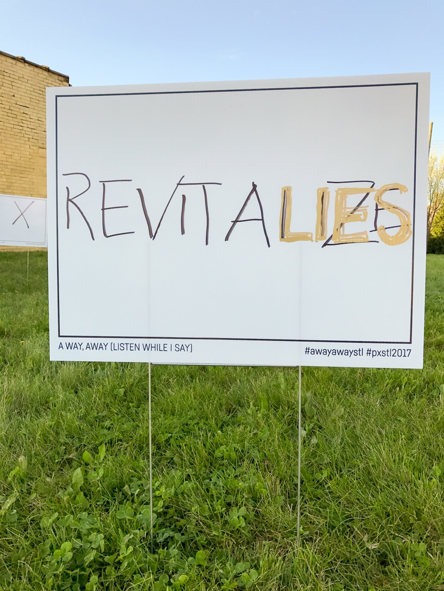 A white placard that reads "REVITALIZES" with "LIES" written over "LIZES" with grassy background.