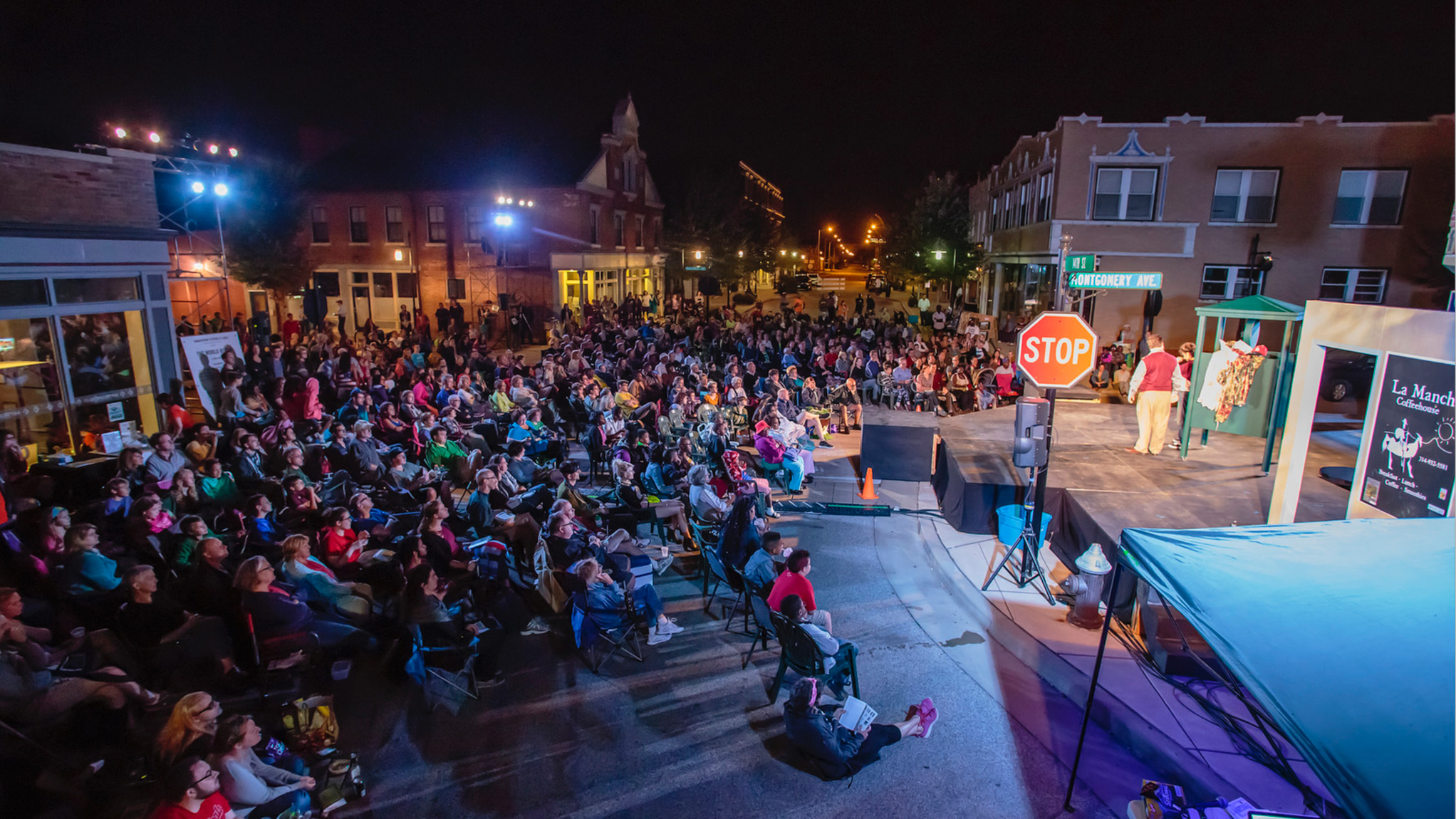 A crowded street watched performers onstage at the Shakespeare Festival St. Louis.