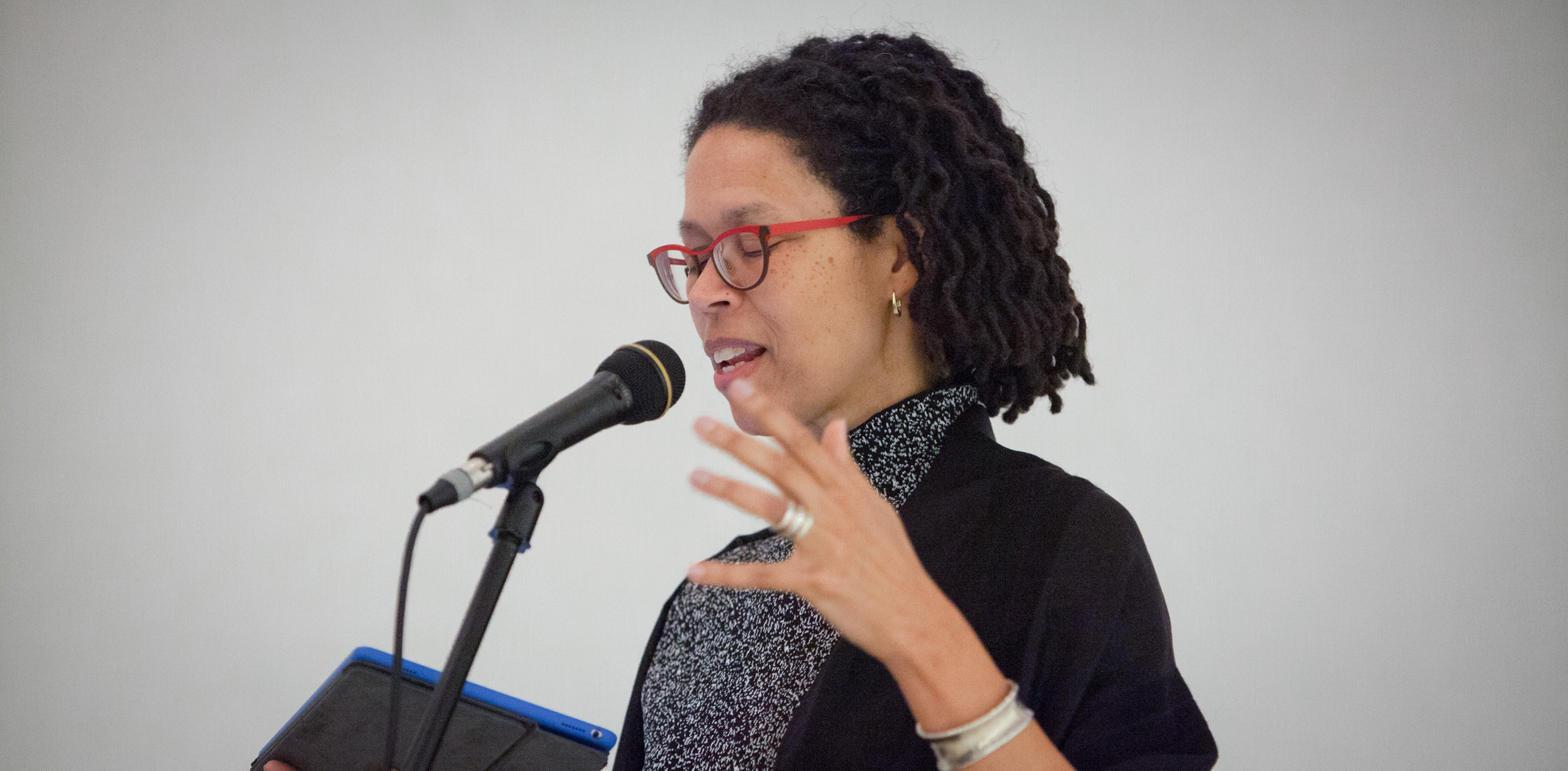 Poet Evie Shockley reads into a microphone.