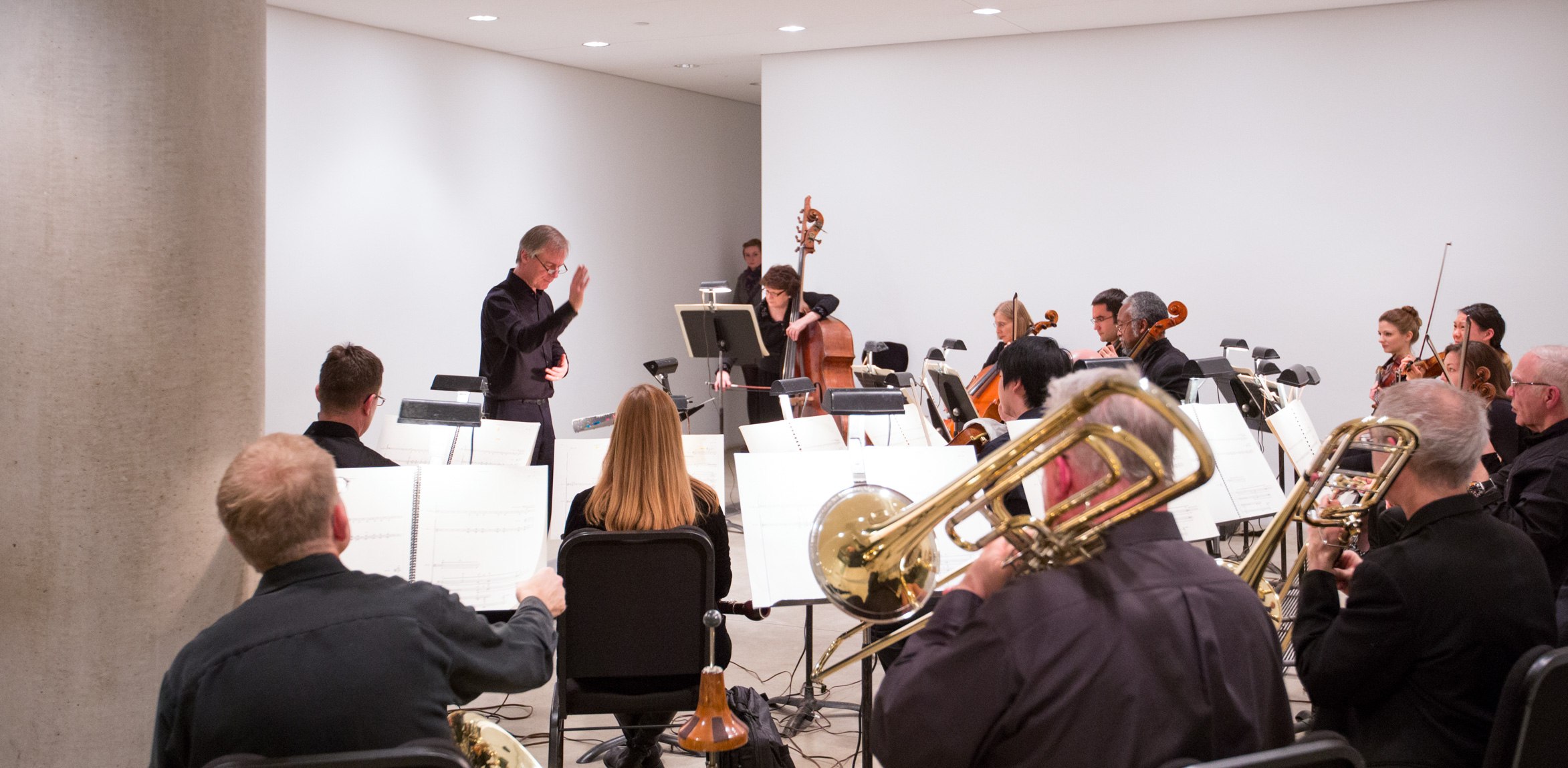 David Robertson conducts a symphony in the Entrance Gallery.