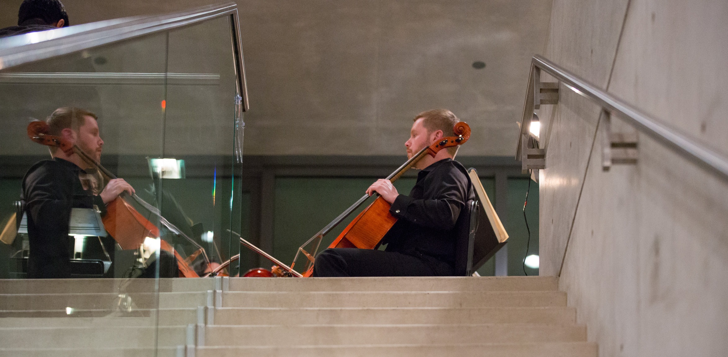 A cellist performs in a group in the Mezzanine.