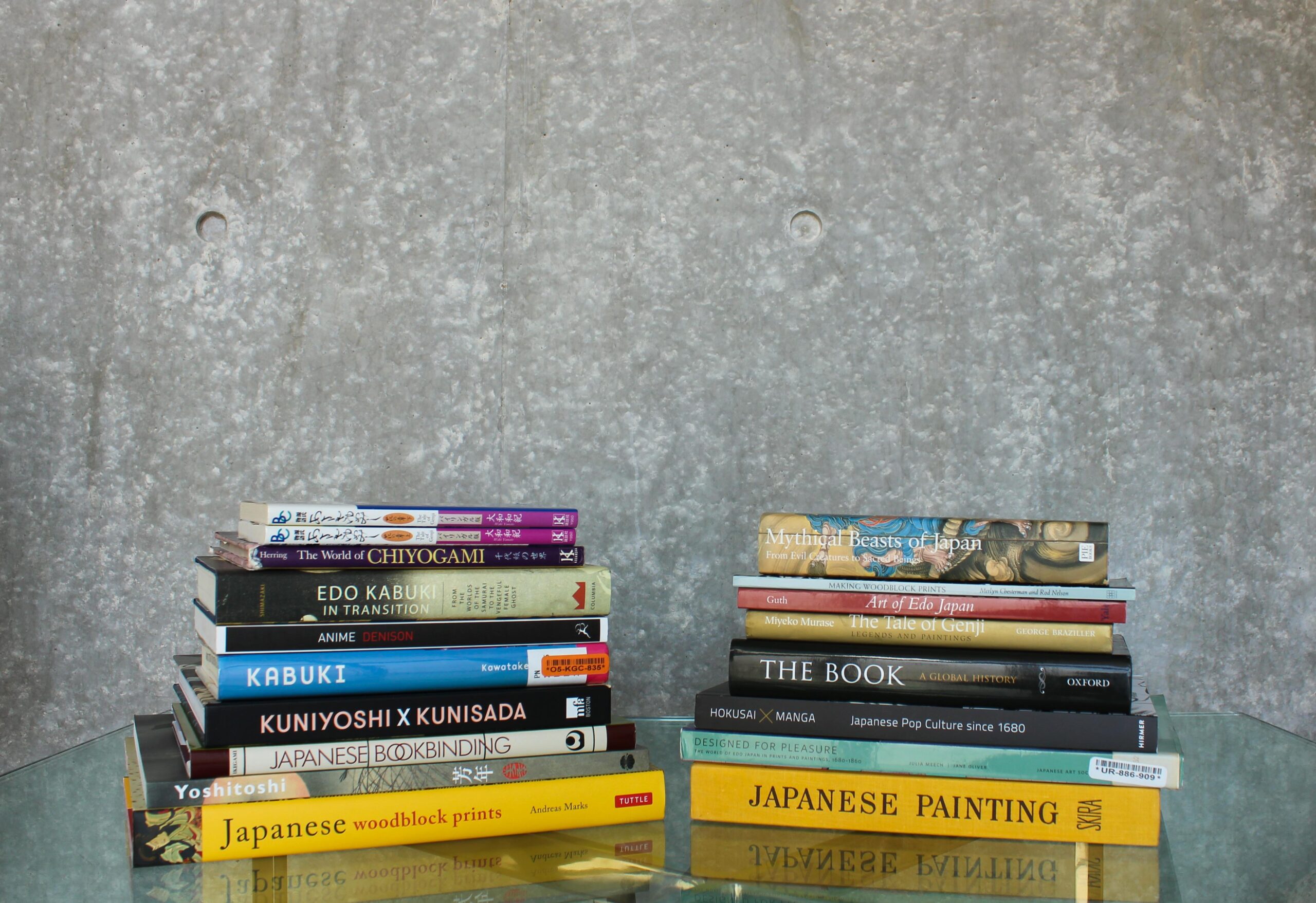 Two stacks of books on view that accompanied and informed the Living Proof exhibition.