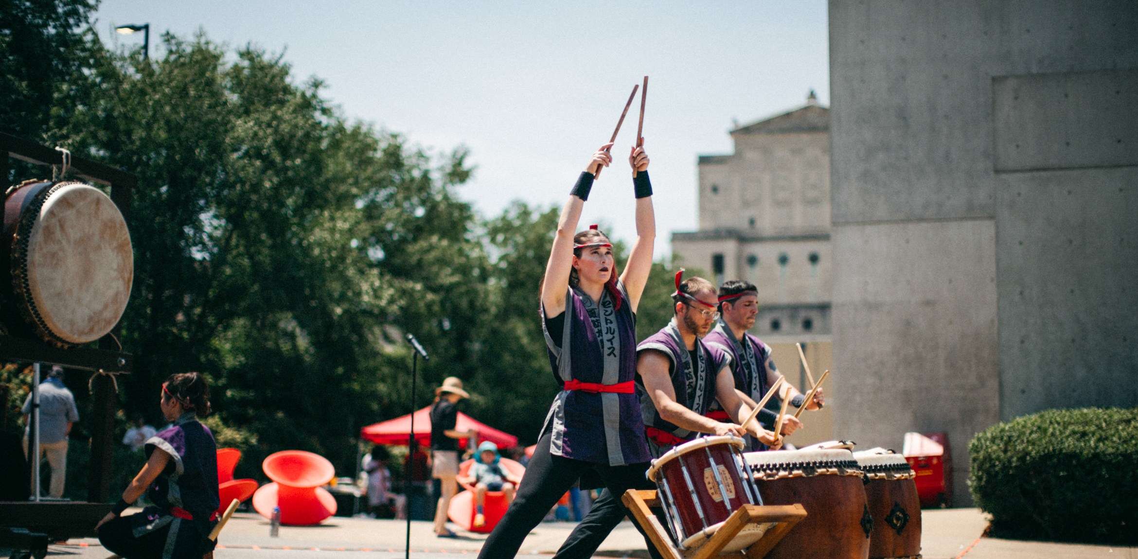 A drumming troupe performs in the Pulitzer's parking lot during the event.