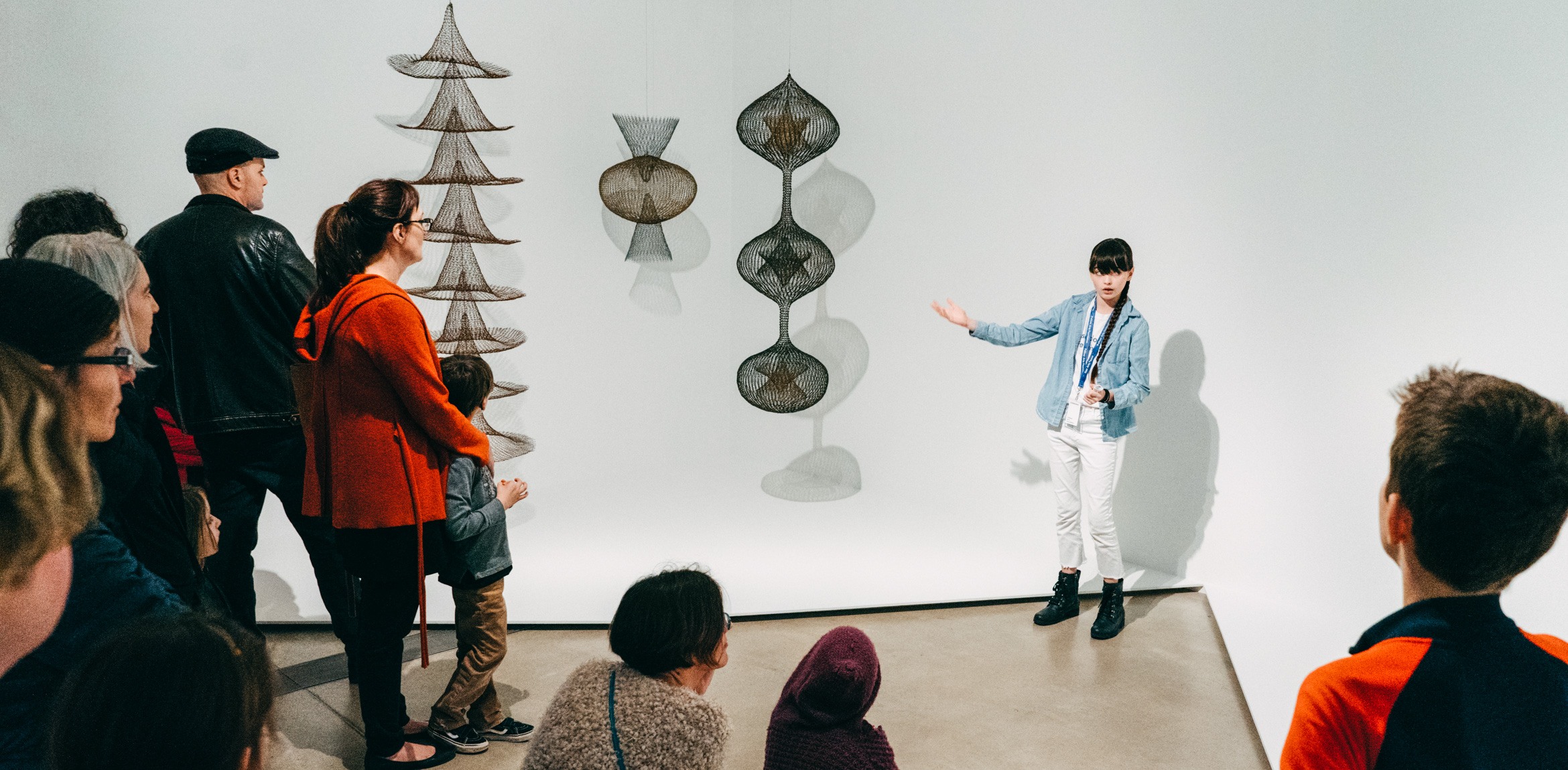 Artist Beatrice Red Star Fletcher gives a tour of Ruth Asawa's exhibition to an audience.