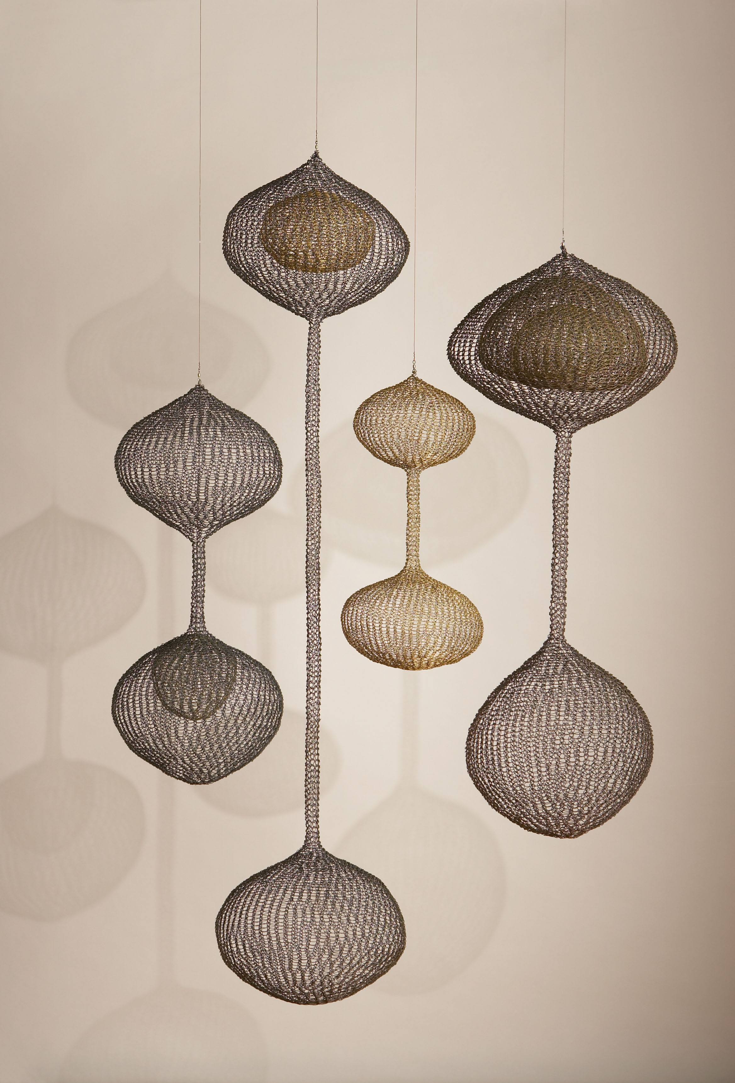 Four hanging wire sculptures by Ruth Asawa.