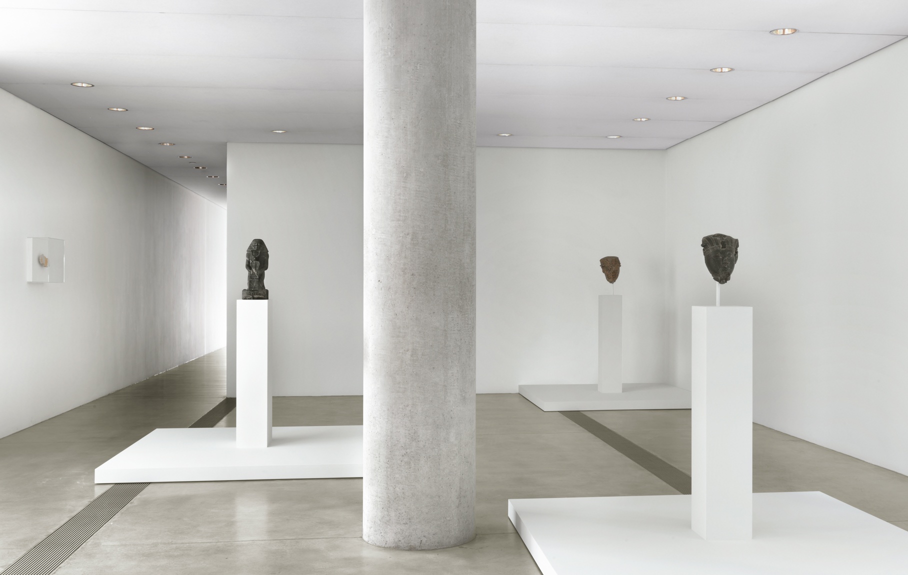 A view of stone sculptures on pedestals in the Entrance Gallery.