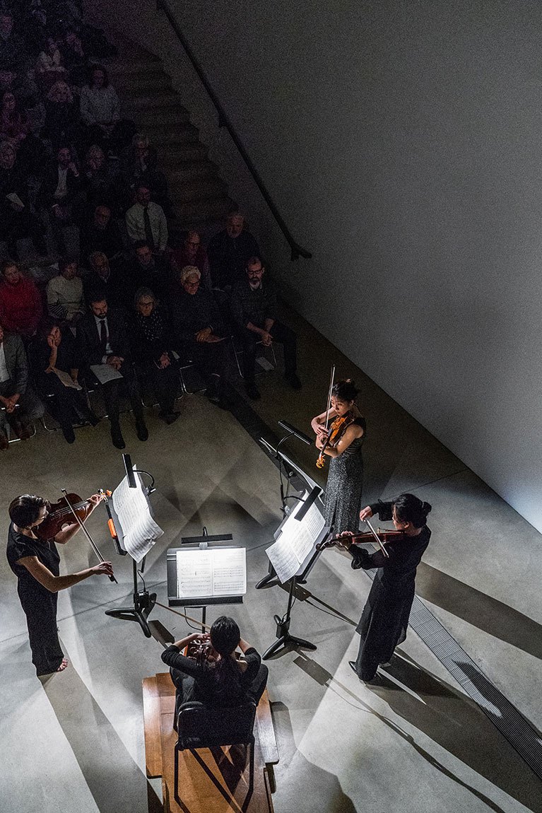 A quartet of string musicians performs in the Lower Main Gallery.