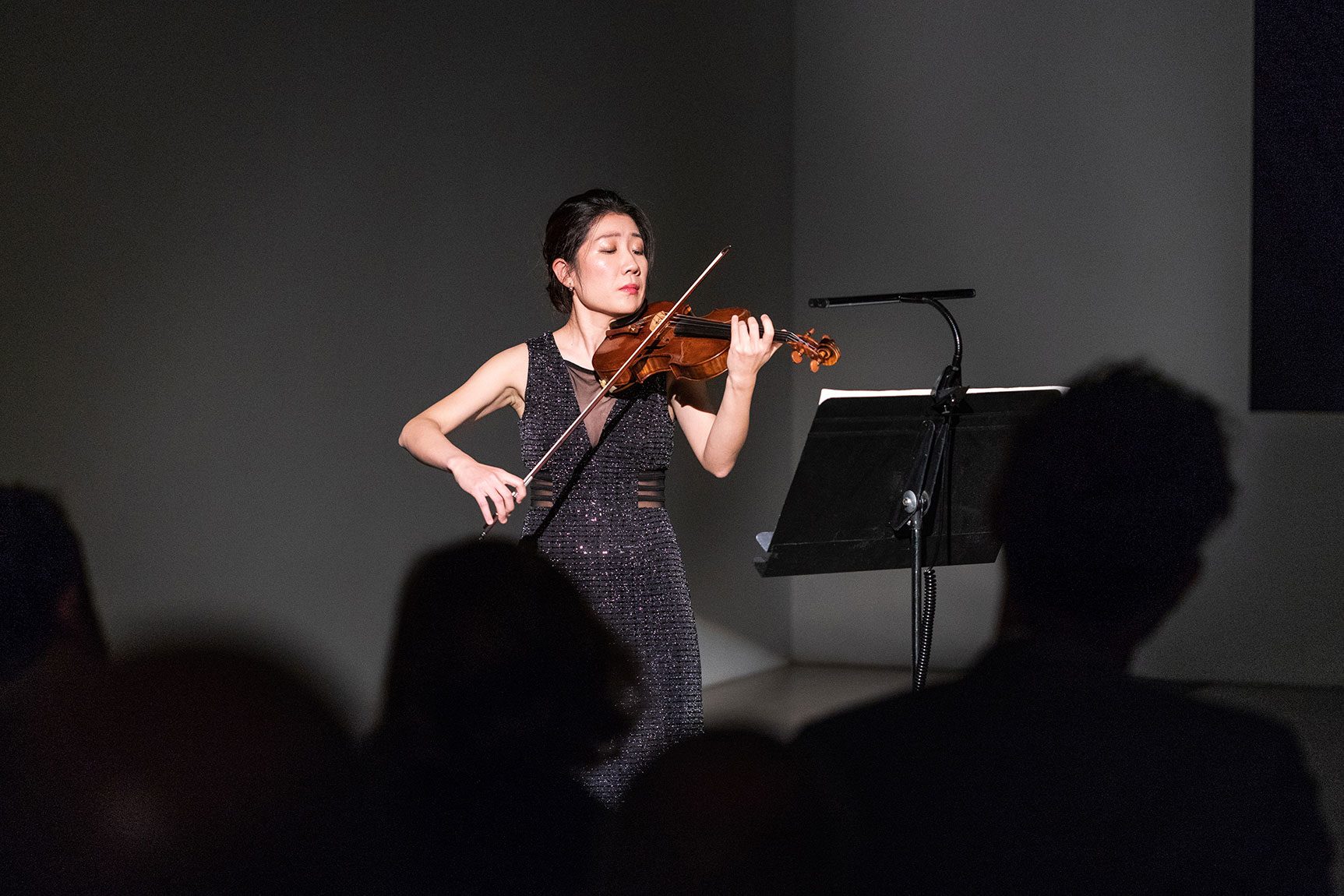 A violinist performs in the Lower Main Gallery.