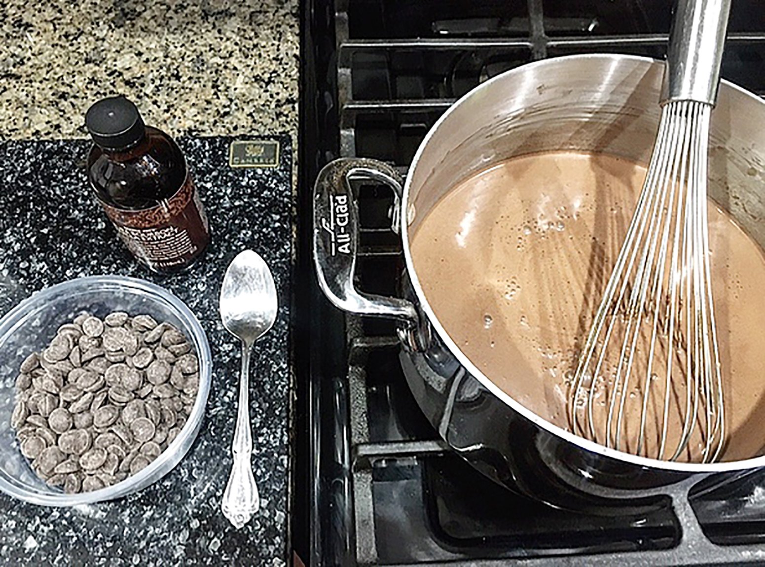 A photo of Summer Wright's process for making chocolate pudding from scratch. A metal bowl with chocolate pudding and a whisk sits on a stovetop, and a spoon, a bowl of chocolate chips, and a vanilla extract bottle sit on the counter beside it.
