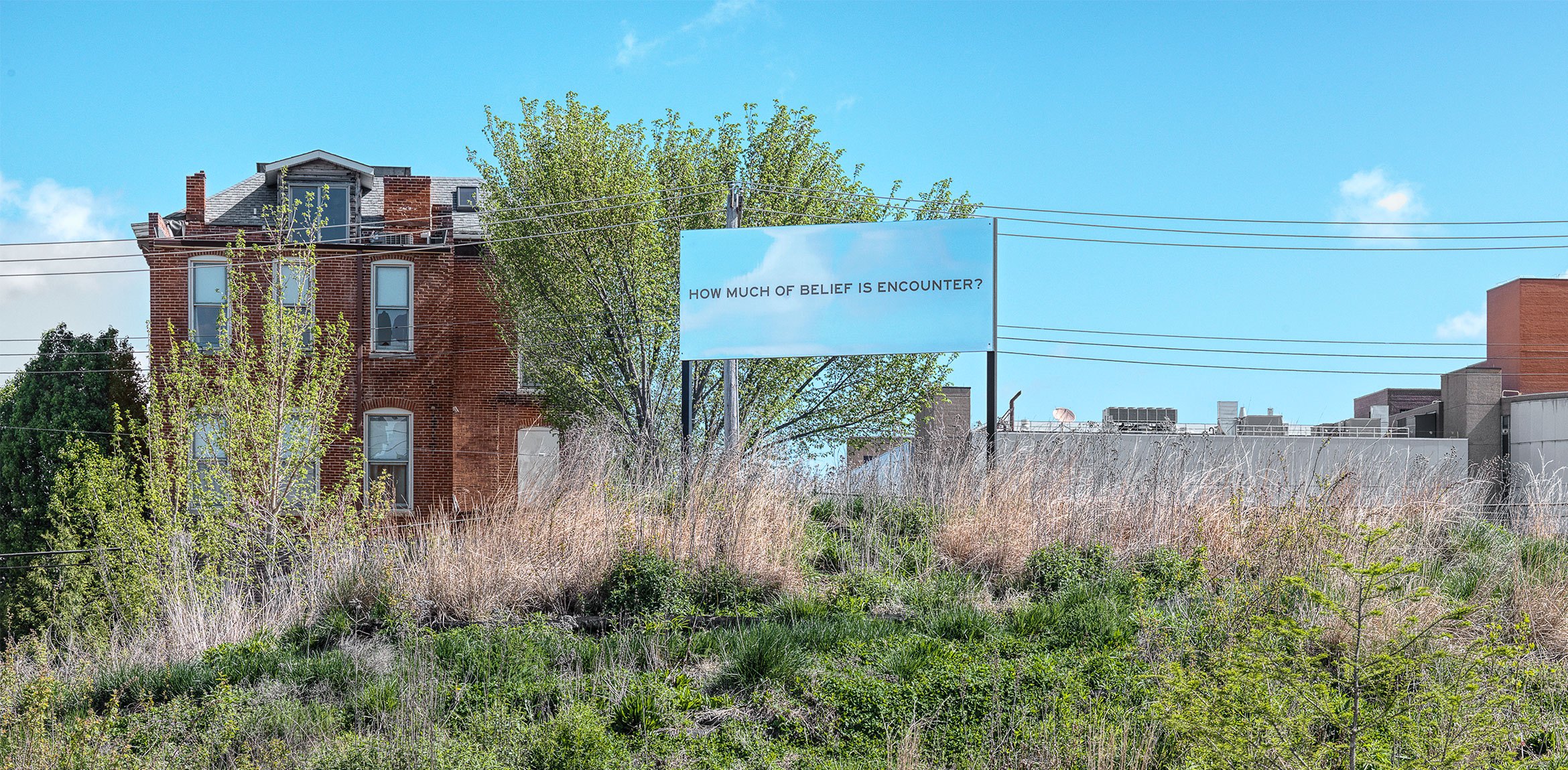 A mirrored billboard work with text by Chloë Bass installed outdoors in Park-Like