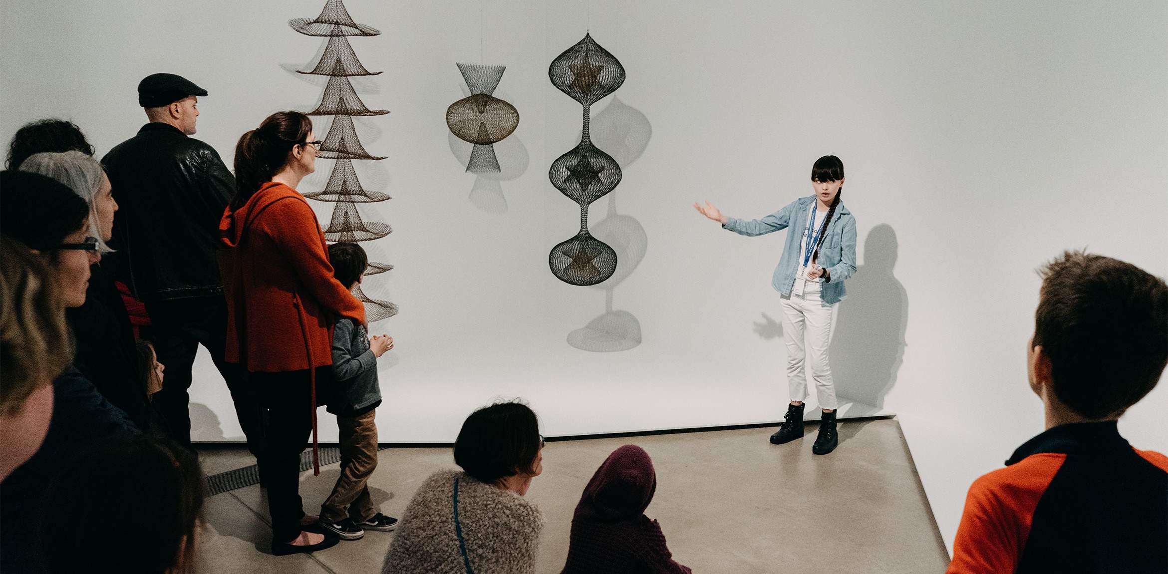 Beatrice Red Star Fletcher leading a tour of Ruth Asawa: Life's Work for adults and children