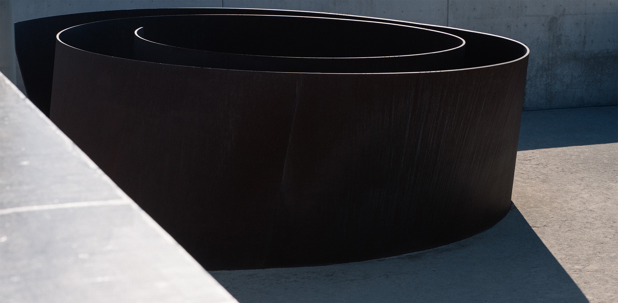Richard Serra's Joe, a large steel sculpture in the shape of a spiral, in the museum courtyard