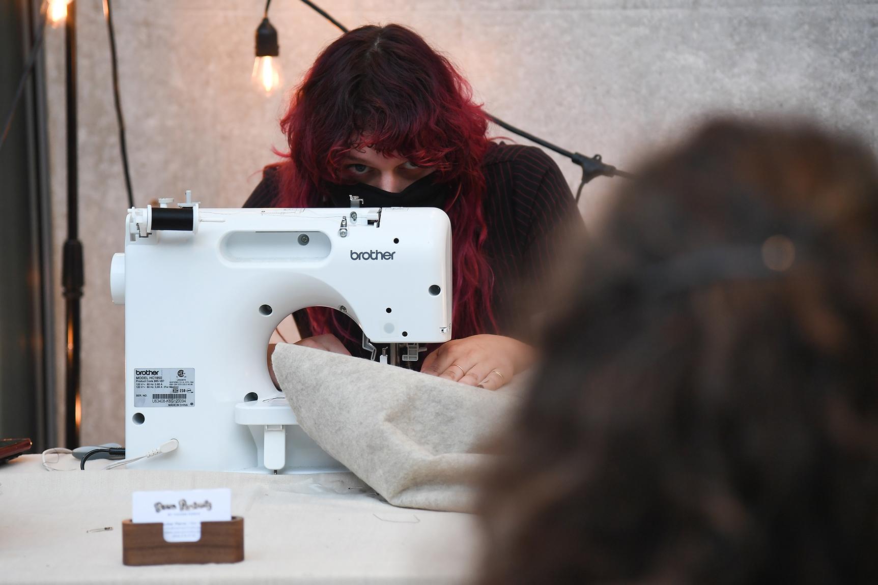 Artist Tucker Pierce working at a sewing machine