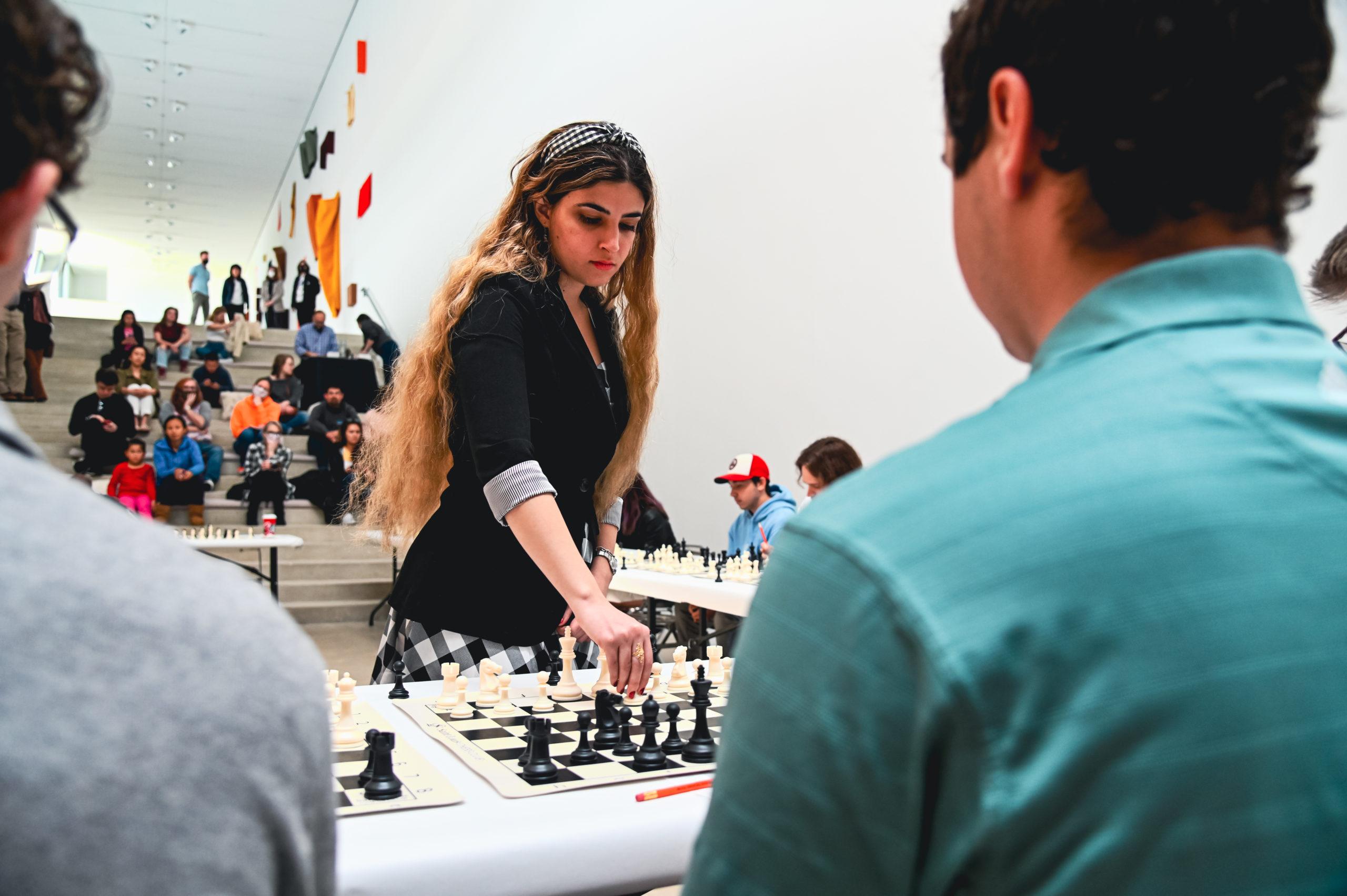 Dorsa Derakhshani playing in a chess simul against twenty-three people at the Pulitzer.