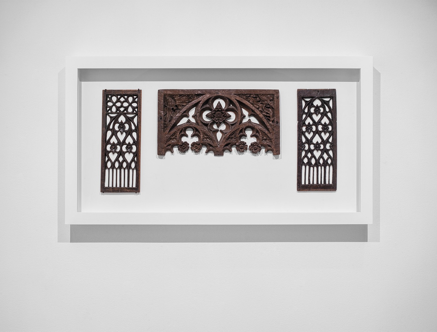 Two decorative wooden panels with a wooden arch in the middle. Works from the middle ages on view at the Pulitzer Arts Foundation.