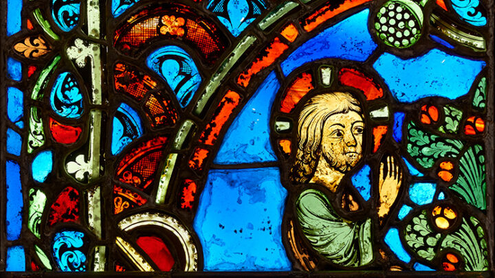 Stained glass window of person and tree