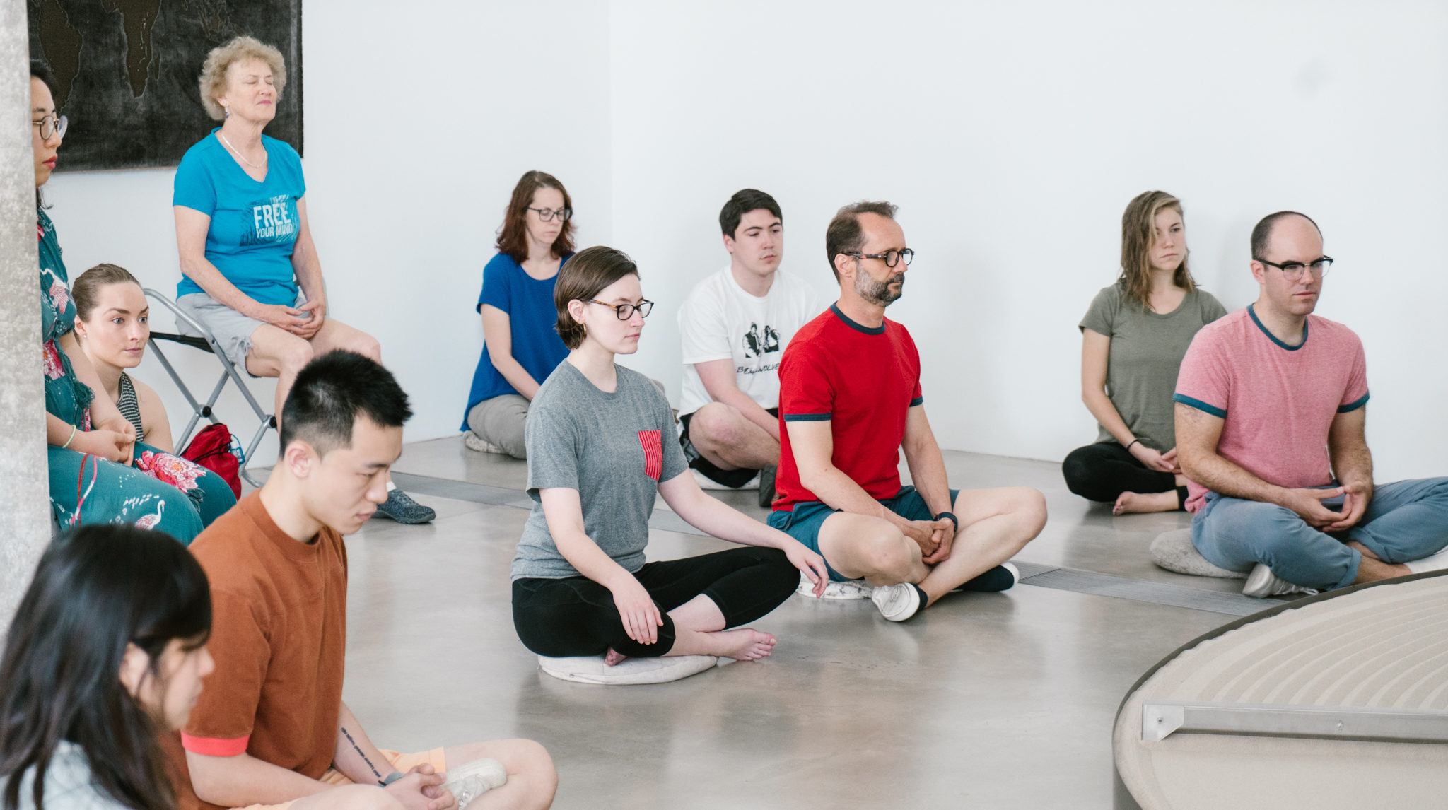People practicing meditation in the Pulitzer galleries