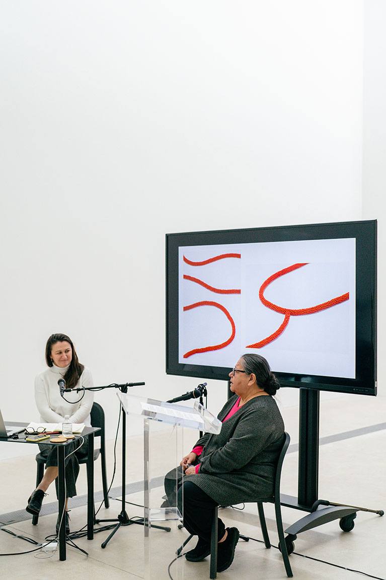 Curator of the Pulitzer, Tamara Schenkenberg and artist, Faye HeavyShield, sitting down speaking to an audience