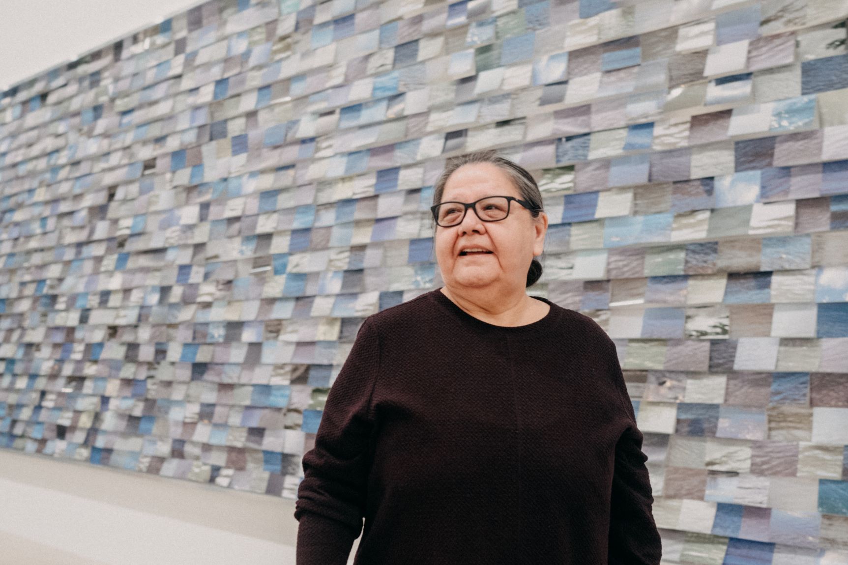 Faye HeavyShield with her commissioned work "aiyo niitahtaan" at the Pulitzer Arts Foundation