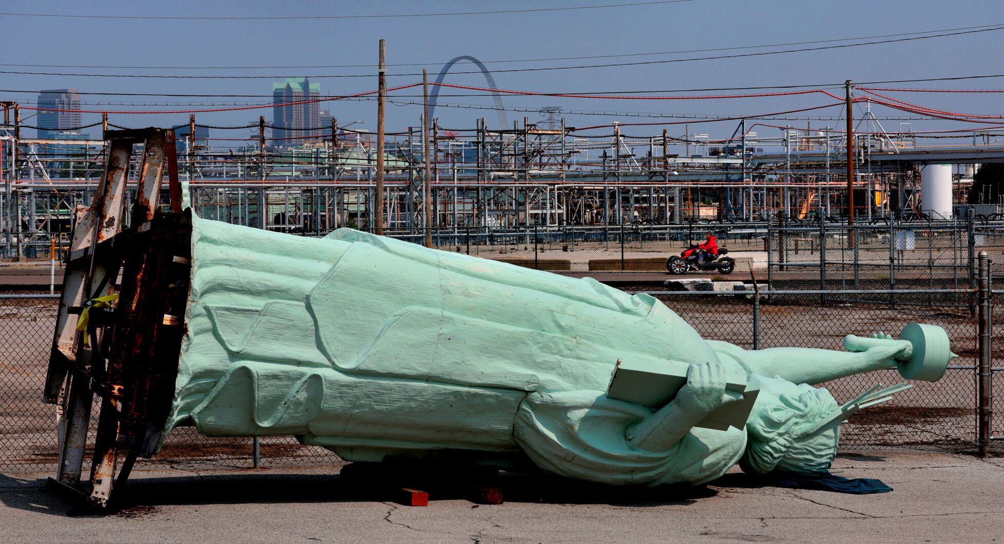 Little "statue of liberty" laying on it's back in front of the National Building Arts Center