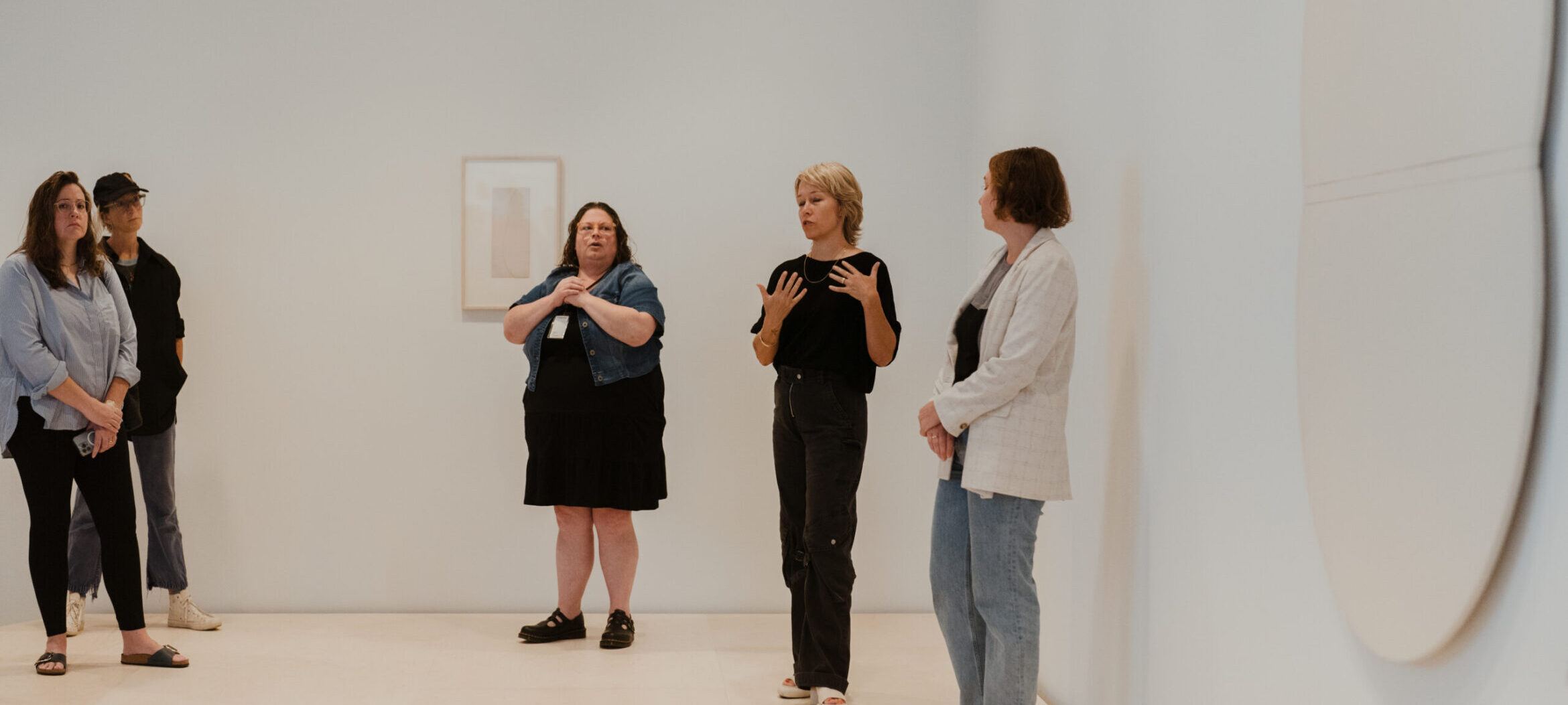 Artist and curator with an ASL interpreter providing tour of "Sarah Crowner: Around Orange."