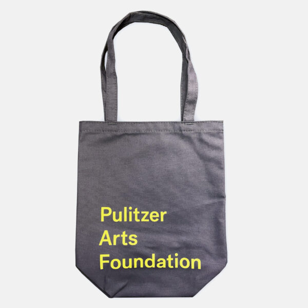 A product shot of a grey tote bag with yellow lettering