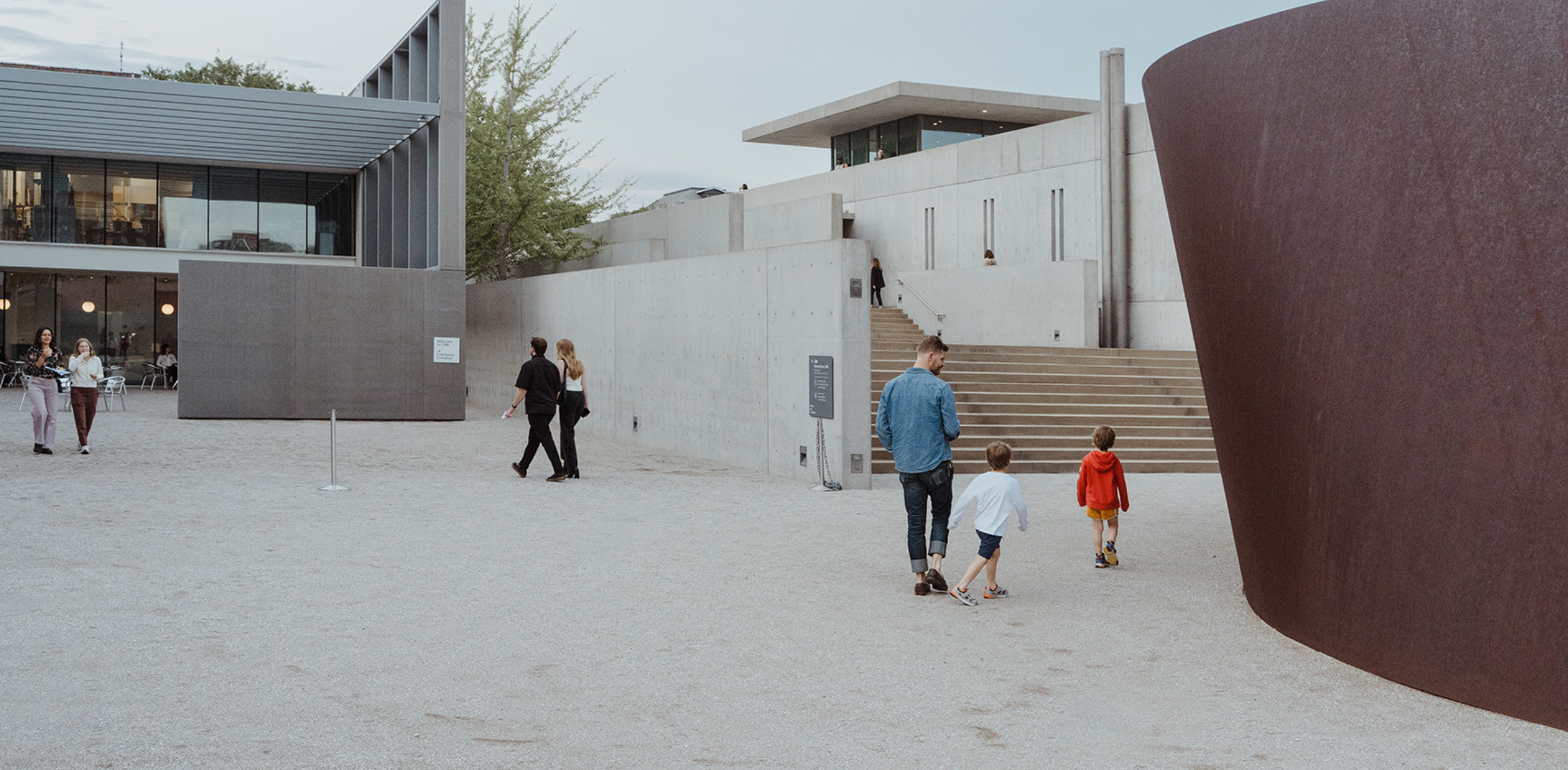 People walking through the shared courtyard at CAM and Pulitzer